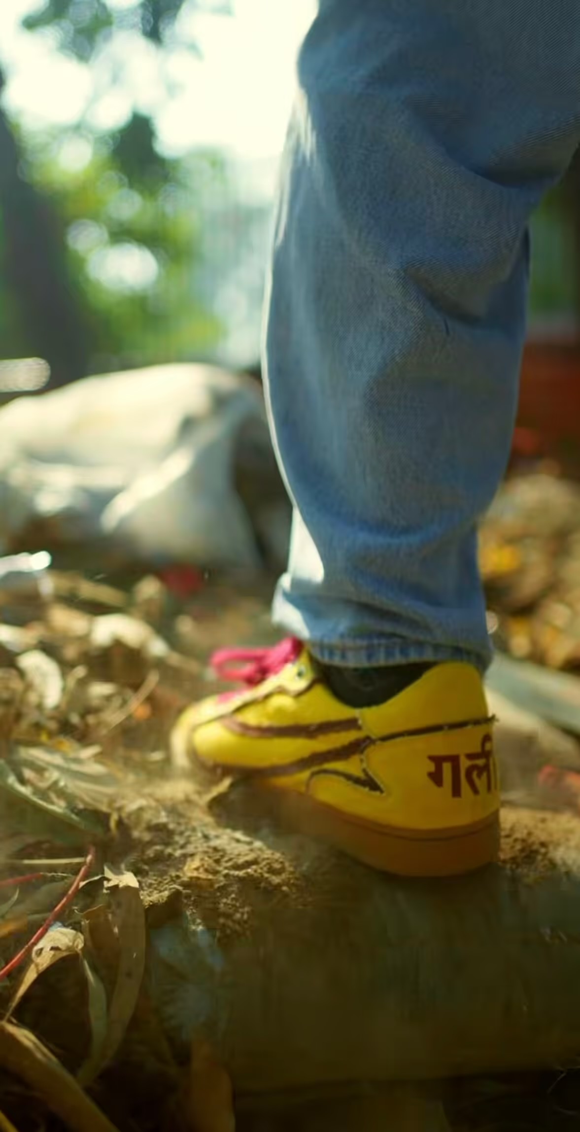 Yellow Gullylabs sneakers on a rocky path