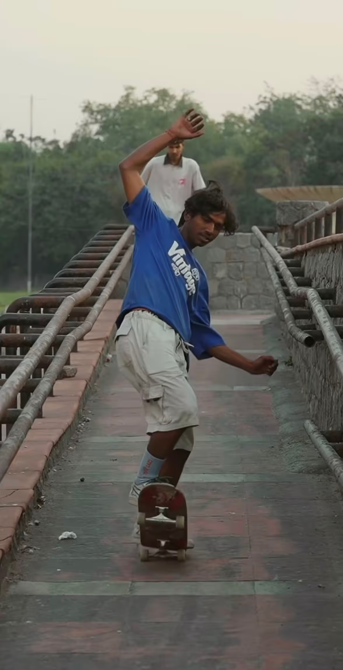 Skateboarder riding down a concrete ramp in Delhi